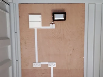 A container electric board on the wall of a container